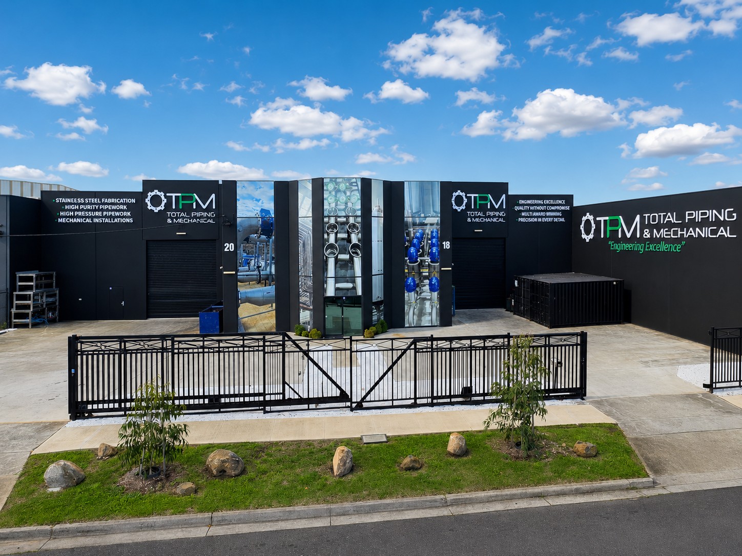 TPM workshop signage and perforated window graphics across the industrial facility